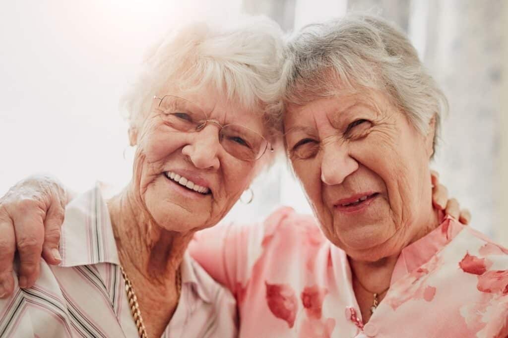 two elderly women smiling together