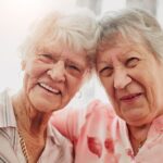 two elderly women smiling together