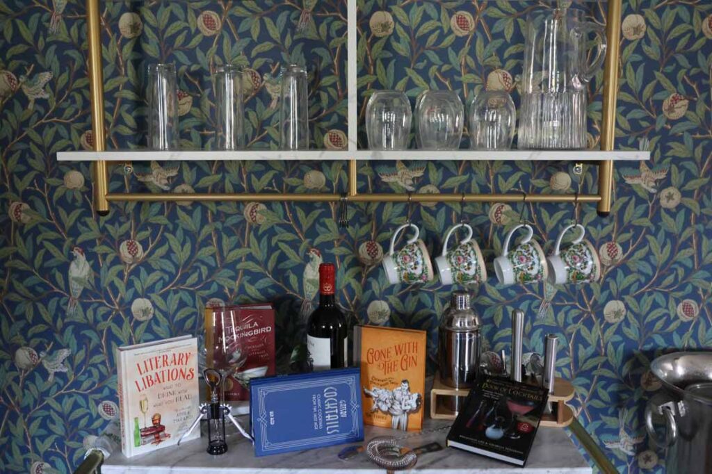 Books, wine and glasses inside the Three Stories Inn