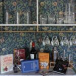 Books, wine and glasses inside the Three Stories Inn