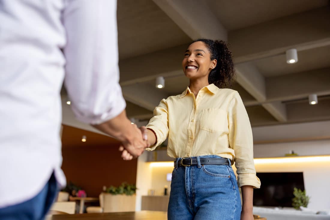 Woman shaking hands at job interview